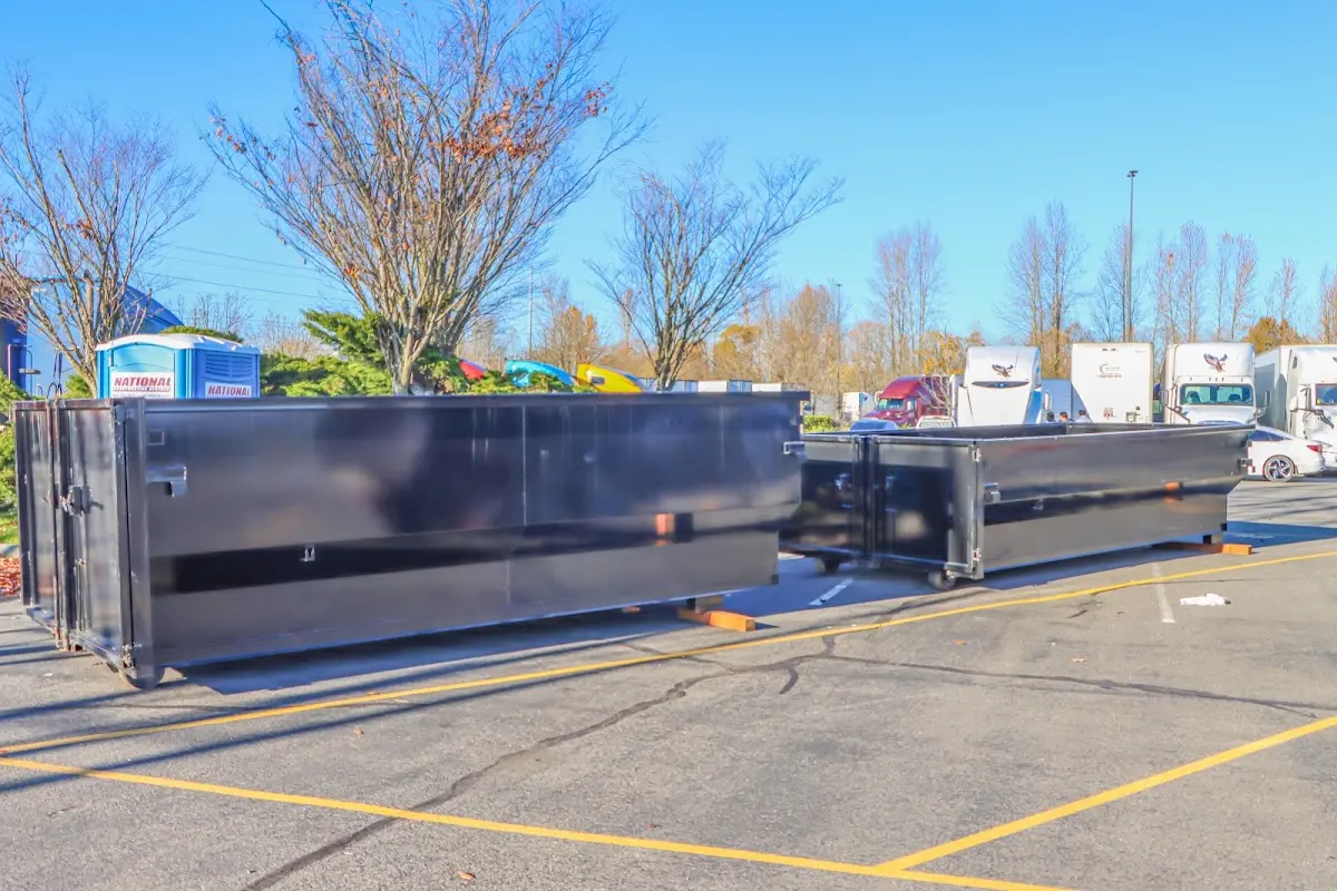 Professional dumpster rental service with roll-off container on residential driveway in Bethlehem